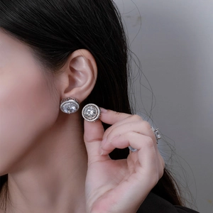Classic 10mm round halo stud earrings in 925 sterling silver worn by a female model