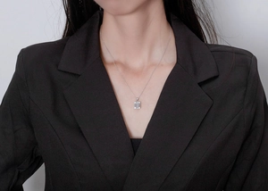 Close-up of S925 silver necklace featuring a rectangular emerald-cut zircon pendant on model