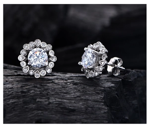 Macro shot of 925 silver sunflower halo earrings with brilliant yellow carbon diamonds
