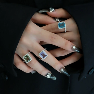 Elegant S925 silver emerald cut rings in blue, green, and violet on a model's hand