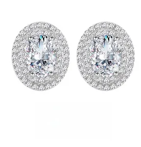 Close-up of 7x9mm oval halo stud earrings with double row sparkling stones