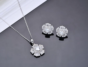Macro view of flower-shaped S925 silver necklace and earrings set with sparkling stones