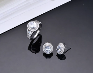 Detailed view of 925 silver oval jewelry set with sparkling cubic zirconia on black surface