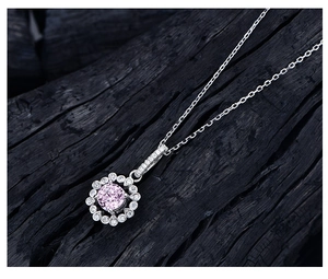 Macro shot of 925 silver flower pendant with 6mm pink diamond and delicate prong setting