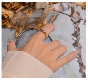 Detailed close-up of 925 silver rainbow eternity ring with colorful gradient gemstones
