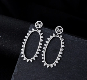 Detailed macro view of S925 silver oval drop earrings with micro-paved sparkling zircon stones