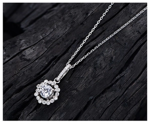 Macro detail of high carbon yellow diamond pendant with 925 silver halo flower design
