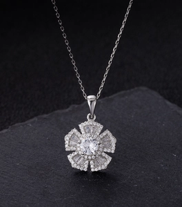 Macro shot of a floral S925 silver necklace with sparkling high-carbon diamonds on stone