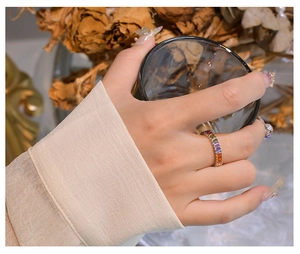 Detailed view of 925 silver rainbow ring with multi-color rectangular gemstones on model