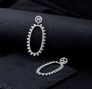 Detailed close-up of S925 sterling silver hollow oval earrings with micro-inlaid zircon