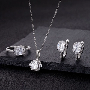 Macro detail of 925 silver jewelry set featuring emerald cut stones and pave diamonds
