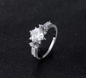 Detail of S925 hallmark on a square-cut sparkling silver ring band with pave settings