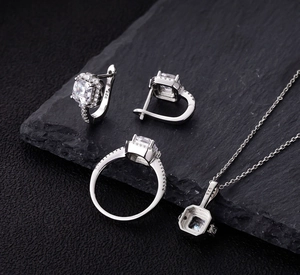 Macro view of 925 silver jewelry set featuring square zircon stones on black stone