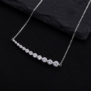 Elegant 925 sterling silver necklace featuring curved sparkling zirconia pendant on sand