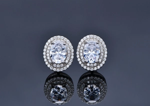 Detail of oval-cut earrings with double halo diamonds and 925 sterling silver settings