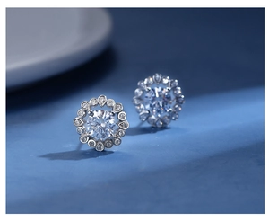 Macro detail of 925 sterling silver flower-shaped stud earrings with yellow carbon diamonds