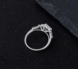 Macro shot of a 925 silver ring featuring a rectangular emerald-cut sparkling gemstone