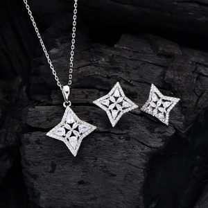 Sparkling S925 sterling silver four-point star necklace and earrings jewelry set on black coal