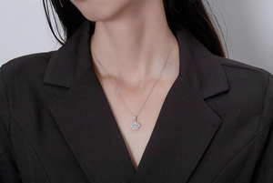 Macro detail of a 925 silver halo pendant necklace with a square-cut zirconia center