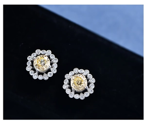 Macro shot of 925 silver halo earrings with 6mm yellow gemstone and cz accents