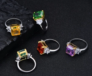 Detailed macro of 925 silver rings set with colorful 13ct radiant emerald cut gemstones