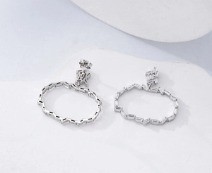 Détail macro de créoles en argent 925 avec zircons baguettes sertis en rail de luxe