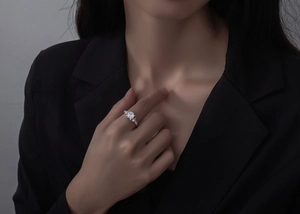 Close-up of 925 silver ring with square-cut clear gemstone and marquise accents on hand