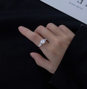 Macro shot of a 925 silver square cut crystal ring with accent side stones on hand