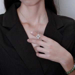 Sparkling S925 sterling silver four-point star pendant necklace worn by a fashion model