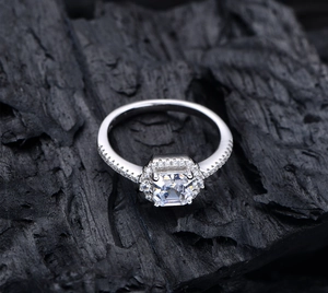Detailed top view of a 925 silver square cut halo ring with side accent diamonds