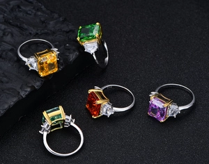 Detailed macro view of S925 silver rings with colorful rectangle gemstones and side diamonds