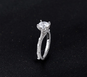 Macro side view of a 7mm round cut diamond ring with 925 silver pave setting details