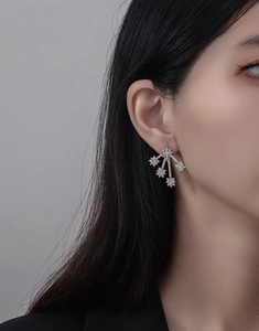 Close-up of elegant S925 silver meteor shower stud earrings with sparkling pavé crystals
