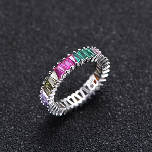 925 silver eternity ring featuring multi-color triangular cut gemstones on black background