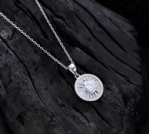 Detail of S925 silver necklace with a tiered round pendant featuring baguette-cut stones
