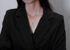 Detailed view of S925 sterling silver flower necklace with sparkling pavé micro-inlay diamonds