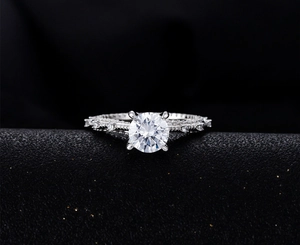Macro shot of 7mm round brilliant cut diamond ring with twisted pave band in 925 silver