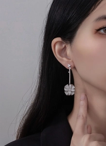 Close-up of a long silver floral drop earring with sparkling micro-pave cubic zirconia