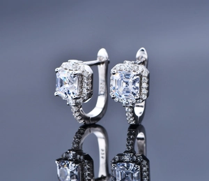 Detailed macro view of S925 sterling silver halo hoop earrings with square cubic zirconia