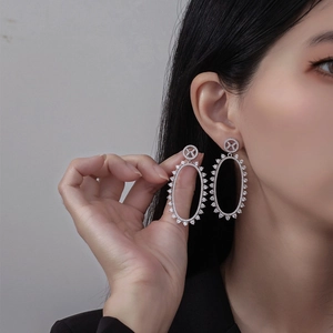 Elegant S925 sterling silver long oval hollow earrings with micro-set zircons on model