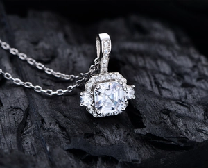 Macro shot of 925 silver square cut halo necklace pendant on dark background