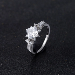 925 silver princess cut square zircon ring with side stone accents on black background