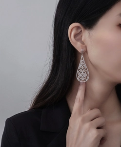 Close-up of luxury S925 silver drop earrings with micro-pave crystals on a model