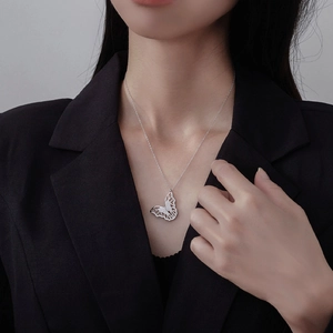Elegant S925 sterling silver butterfly necklace with micro-pave zircons on a model