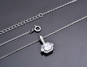 Macro shot of silver 925 jewelry set necklace featuring a square cut sparkling gemstone