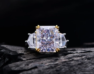 Macro shot of a 13ct radiant cut carbon diamond ring on a textured dark stone background