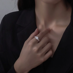 Emerald cut square silver ring with marquise side stones on a model in a black suit