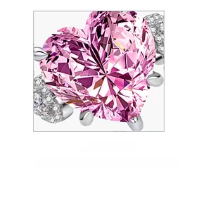 Macro close-up of heart-shaped pink carbon diamond ring with silver claw setting