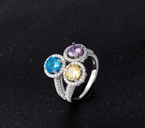 Macro shot of 925 silver ring with purple, blue and yellow round halo gemstones