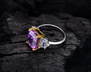 Macro detail of 925 silver ring featuring purple cushion stone and two-tone gold plating